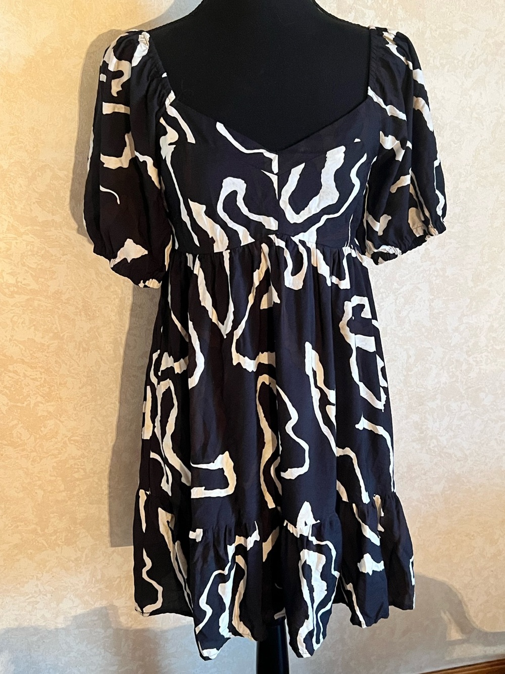 Black & tan patterned mini dress with puff sleeves